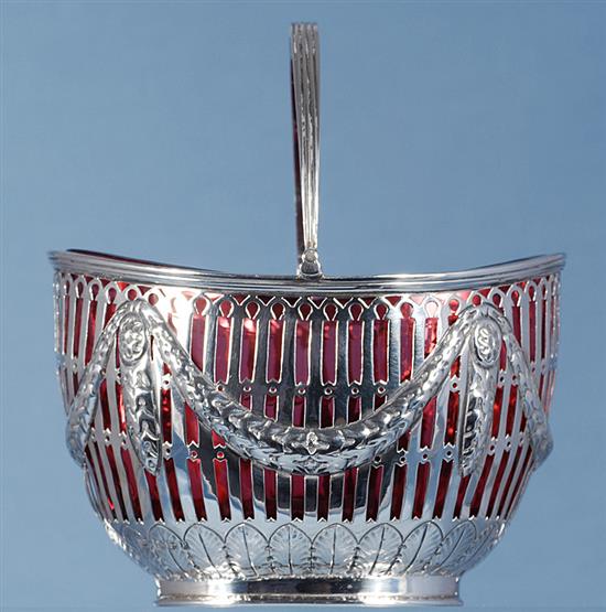 A Victorian silver swing handled sugar basket with cranberry glass liner, length 128mm, weight silver only 5.3oz/151grms